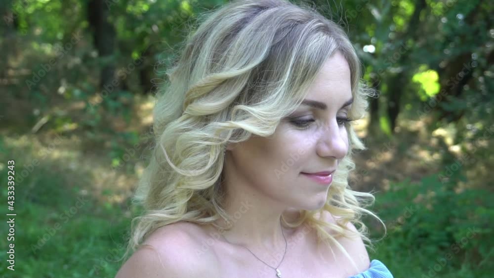 Slow Motion Young woman in the park with flowers Slow Motion Young woman in the park with flowers