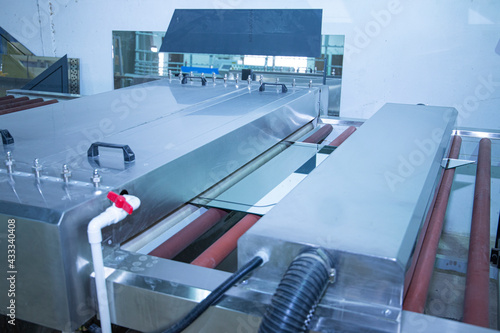 machines working with giant glasses in industrial glass window production factory. glass cutting