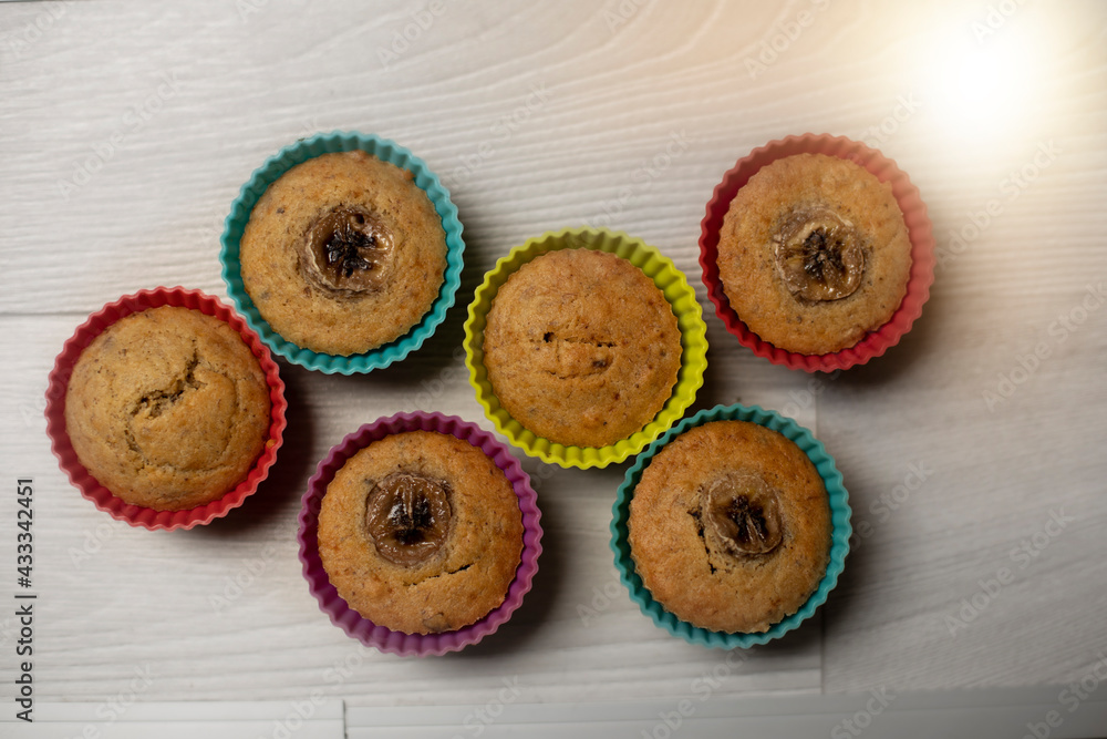 Group of homemade banana muffins on wooden background.