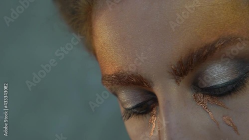 Slow Motion Young woman holding prism up to eye, studio shot