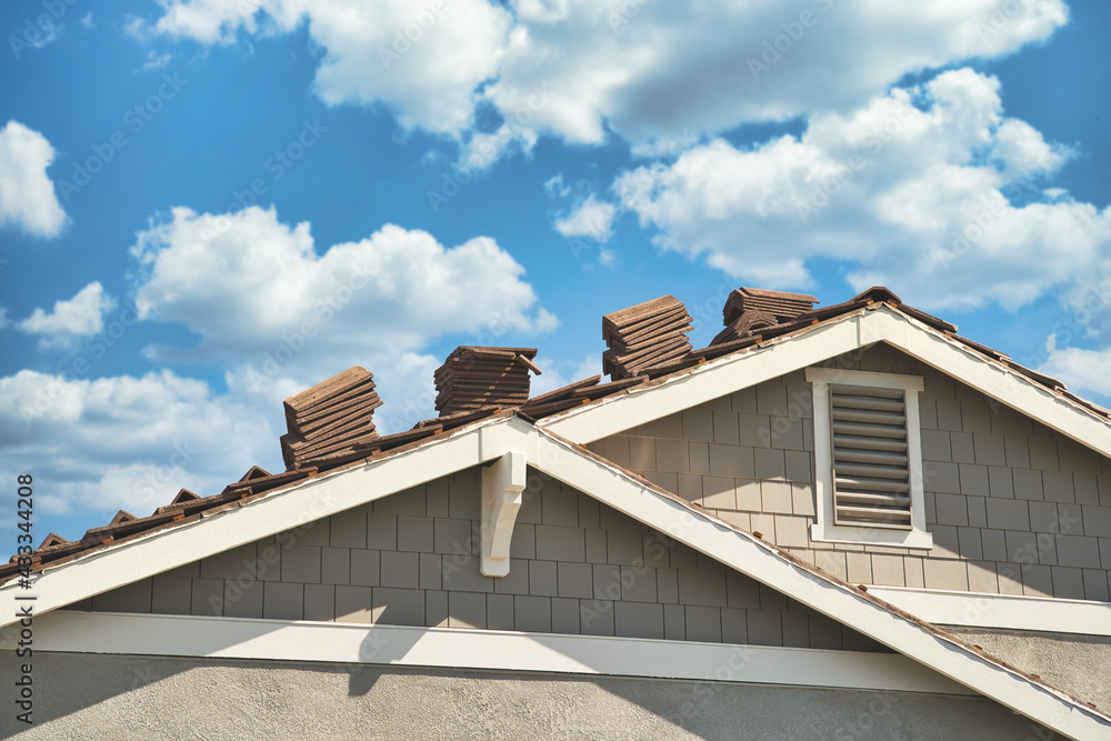 Concrete roofing tile installation with roof tiles lined up in rows on