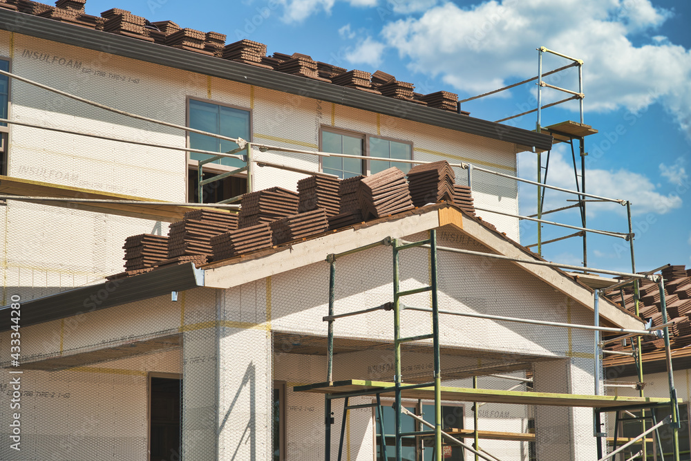 Concrete roofing tile installation with roof tiles lined up in rows on
