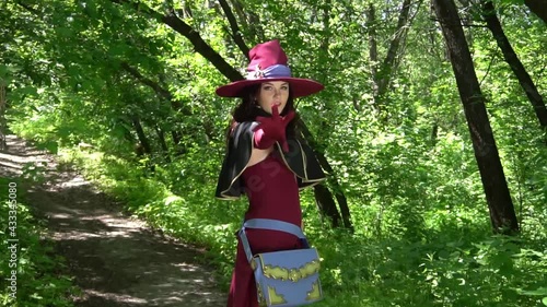 Pretty young brunette woman dressed as a fairy with magic wand cosplay character