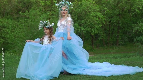 Slow Motion Woman princess in family look blue dress long train medieval