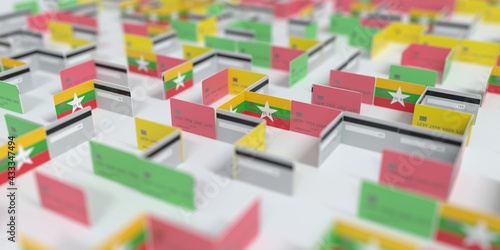 Flag of Myanmar on the mockup credit card maze. Financial difficulties related 3D rendering