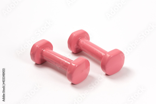 Two pink dumbbells isolated on white background