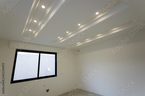 Room interior after renovation, unfurnished apartment with white walls and color pattern on the wall