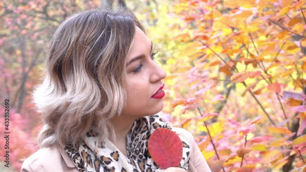 Slow Motion Happy pretty blonde girl walking in autumn park Slow Motion Happy pretty blonde girl walking in autumn park