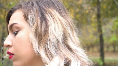 Portrait of a satisfied woman looking at side in a park in autumn season