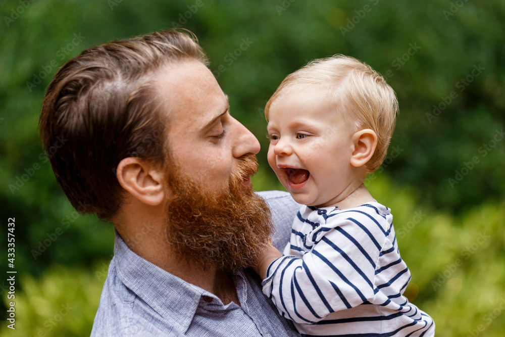 Portrait of father and baby girl, outdoors, laughing Portrait of father and baby girl, outdoors, laughing