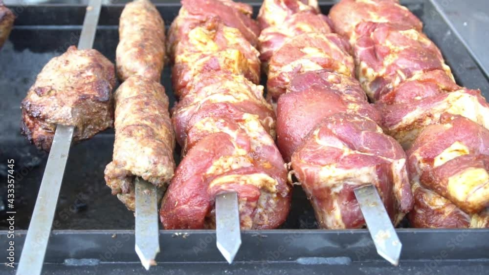 Slow Motion Marinated shashlik preparing on a barbecue grill over charcoal. Slow Motion Marinated shashlik preparing on a barbecue grill over charcoal.