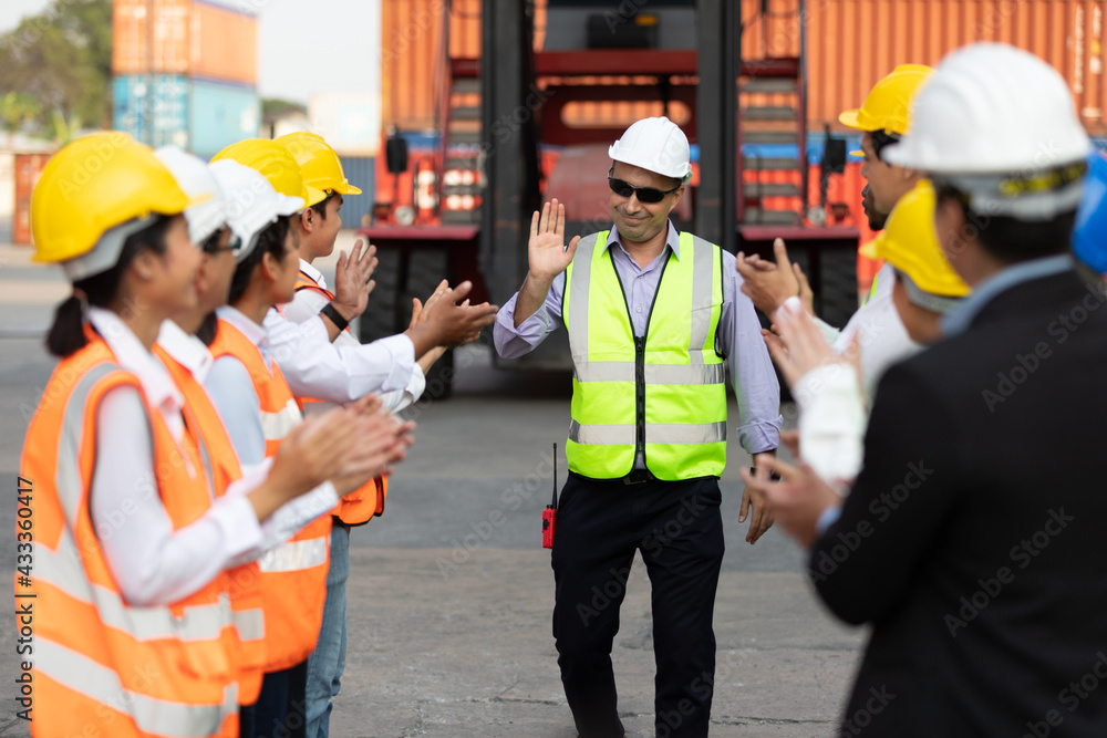 warehouse boss engineer with factory workers raise hand and