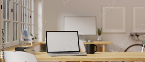 3D rendering, laptop with mock-up screen on wooden table beside the window in home office © bongkarn