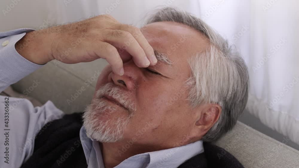 Asian Elderly man sleep on sofa and have pain head. Asian Elderly man sleep on sofa and have pain head.