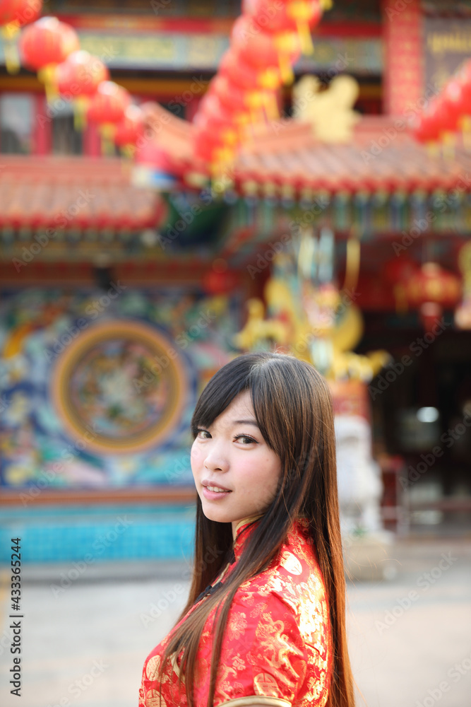 beauty woman wear red cheongsam looking and smile in chinese new year beauty woman wear red cheongsam looking and smile in chinese new year