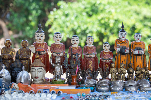 Handmade monk figurine and other souvenir in a tourist stall on the street market near Inle Lake in Burma, Myanmar