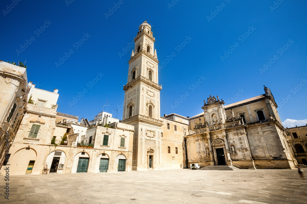 Square of the famous basilica Church of the Holy Cross. Historic city of Lecce, Italy. Blue sky cloudless.