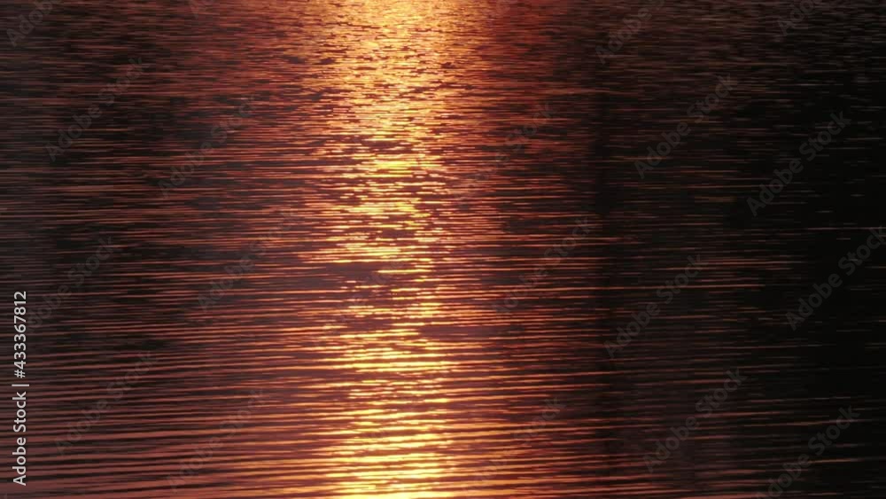 sunset reflection on the water, beautiful water ripples, golden color sunset reflection on the water, beautiful water ripples, golden color