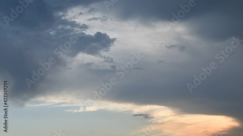 Beautiful evening time-lapse of dark rainy and orange clouds