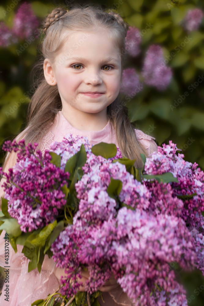 Cute beautiful little girl with lilac in pink dress Cute beautiful little girl with lilac in pink dress