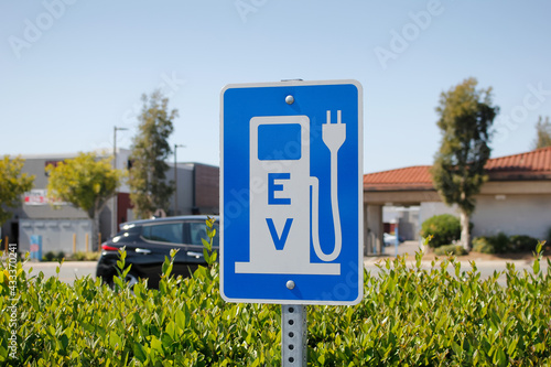 A view of a city sign and symbol for electric vehicle parking and charging. photo