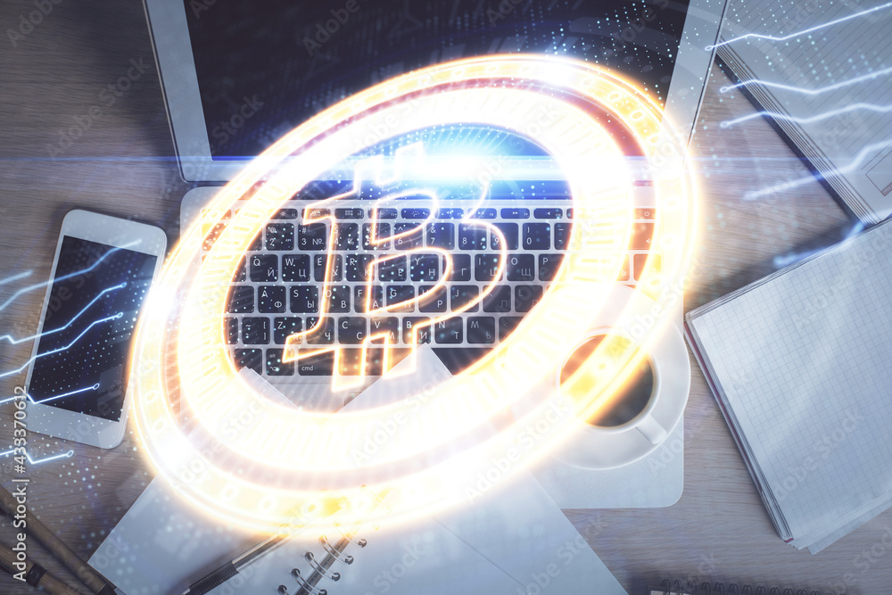 Blockchain theme hologram drawings over computer on the desktop background. Top view. Double exposure. Blockchain theme hologram drawings over computer on the desktop background. Top view. Double exposure.