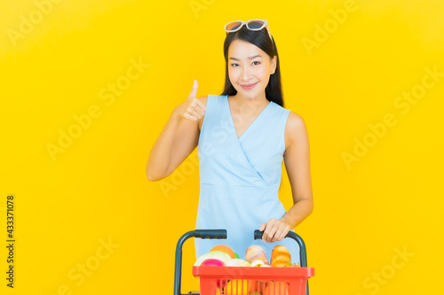 Portrait beautiful young asian woman smile with grocery basket