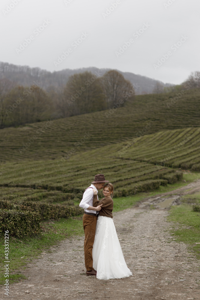 The couple enjoys the view of nature among the tea plantations. A farm-style wedding on a mountain tea plantation.