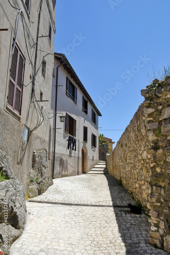 Fototapeta Naklejka Na Ścianę i Meble -  A street between old medieval stone buildings of Bassiano, historic town in Lazio region, Italy.