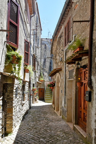 A street between old medieval stone buildings of Bassiano  historic town in Lazio region  Italy.