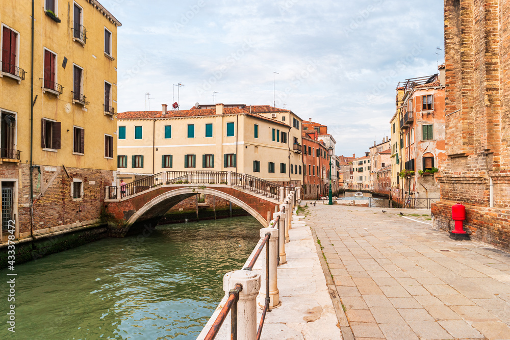 Venice, Italy. Picturesque Vinican landscape with old Italian houses and a bridge over the canal.