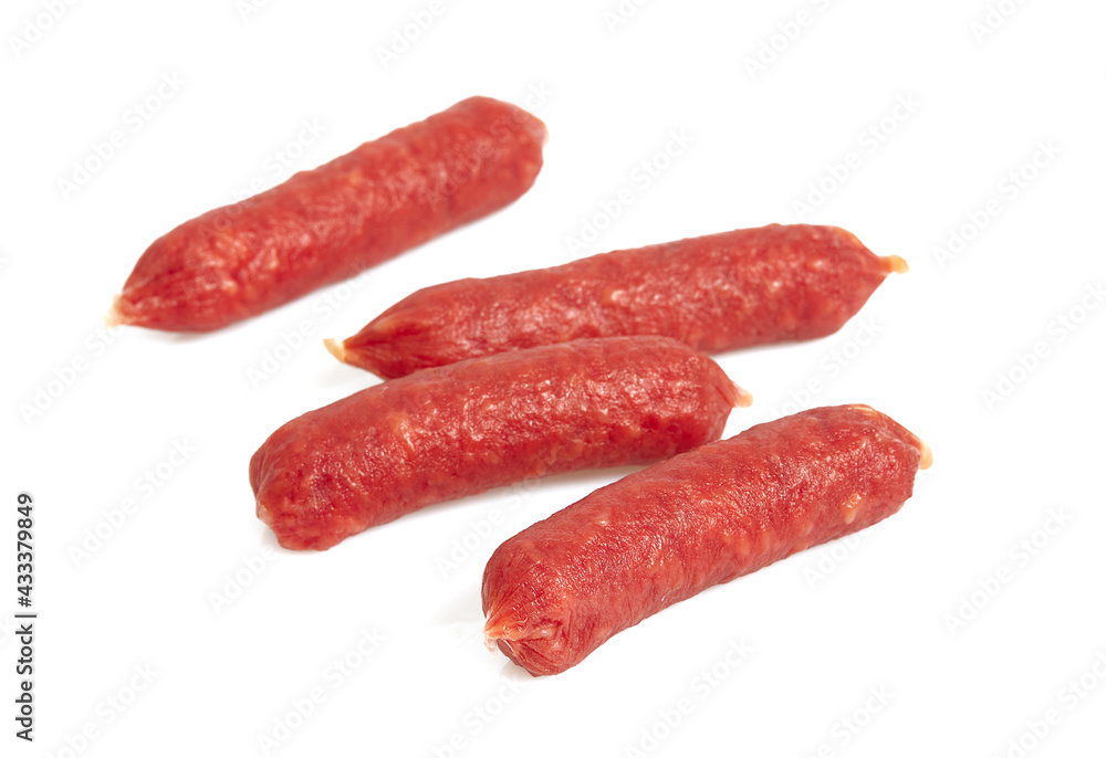 Pile of mini smoked sausages isolated on whit