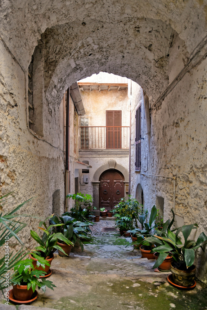 Sonnino, Italy, 05/10 / 2021. A street between old medieval stone buildings of a historic town in Lazio region, Italy.