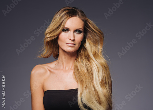 Beautiful woman withblonde hairstyle beauty over dark background
