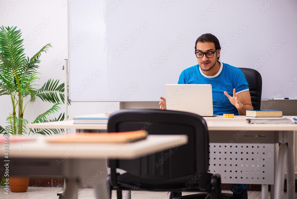 Young male student in the classroom Young male student in the classroom