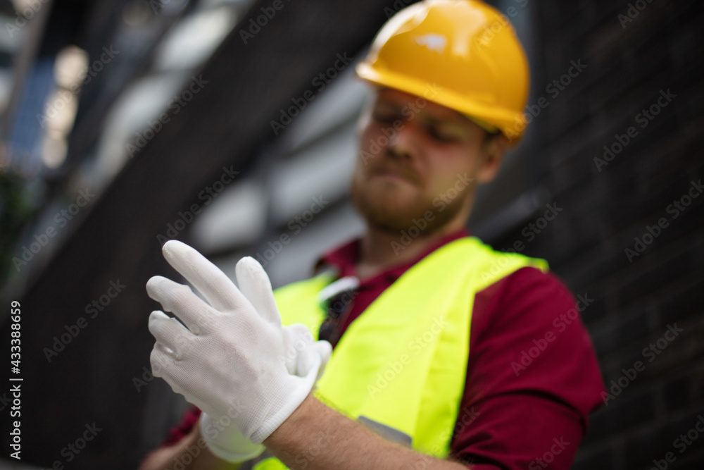 Preparing for work. Worker puts white gloves on his hand. Focus is on hand. Preparing for work. Worker puts white gloves on his hand. Focus is on hand.