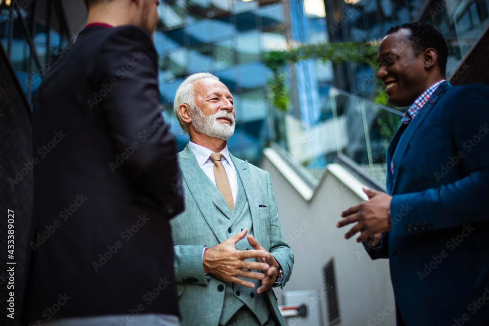 Three business men talking. Focus is on senior man. Three business men talking. Focus is on senior man.