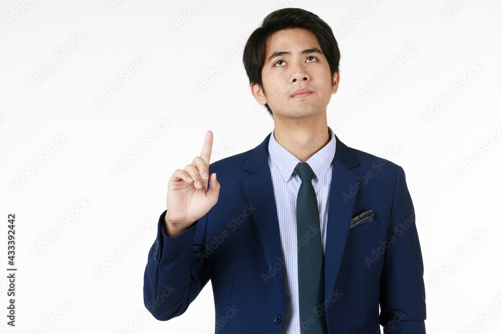 Male manager stand up, pointing his finger upwards with a serious expression. Seems like he want to find a solution for his problem. White background help feeling of photo not too heavy.