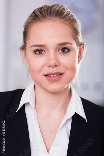 Closeup portrait of attractive young businesswoman in white shirt and black jacket