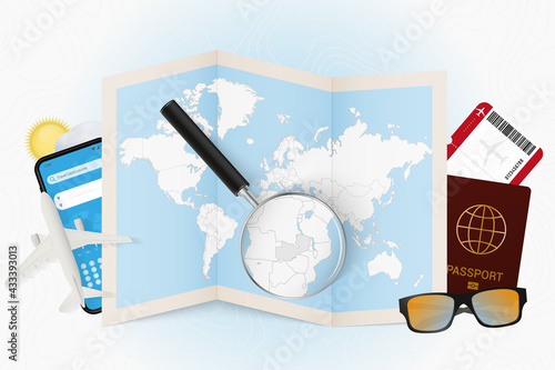 Travel destination Zambia, tourism mockup with travel equipment and world map with magnifying glass on a Zambia.