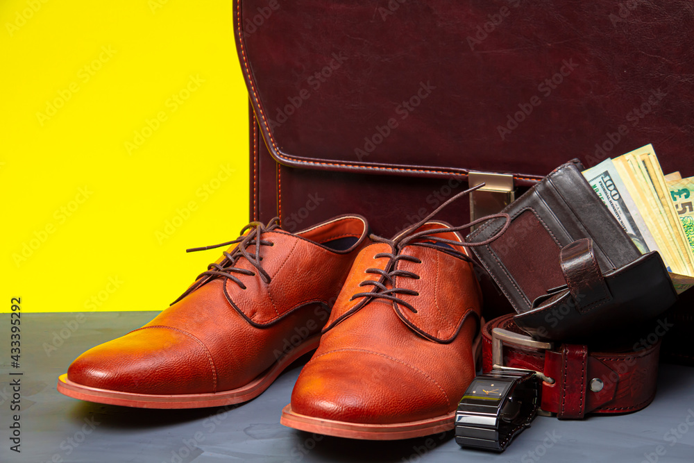 Collection of men's accessories. Men's shoes, belt, watch, wallet with money and briefcase. Mens accessories background.