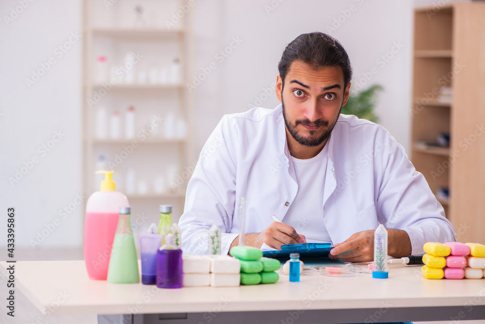 Young male chemist testing soap in the lab Young male chemist testing soap in the lab