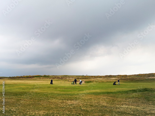 Raining on the fairway during a game of golf at Porthcawl in South Wales. 