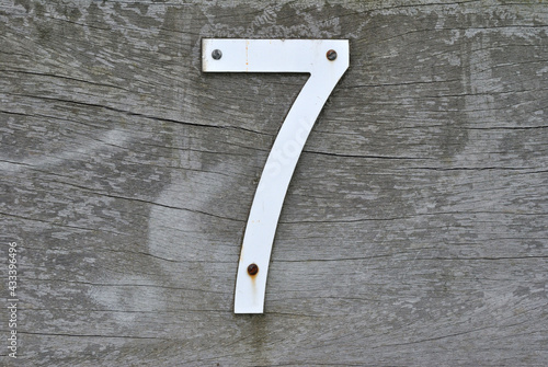 Metal Number Seven Attached to Timber Beam 