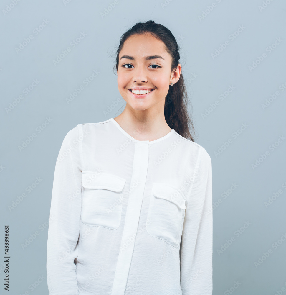 Beautiful brunette woman with long hair in white shirt and jeanse over gray background happy smile teeth Beautiful brunette woman with long hair in white shirt and jeanse over gray background happy smile teeth