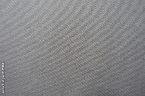 Surface of simple light grey cotton fabric from above
