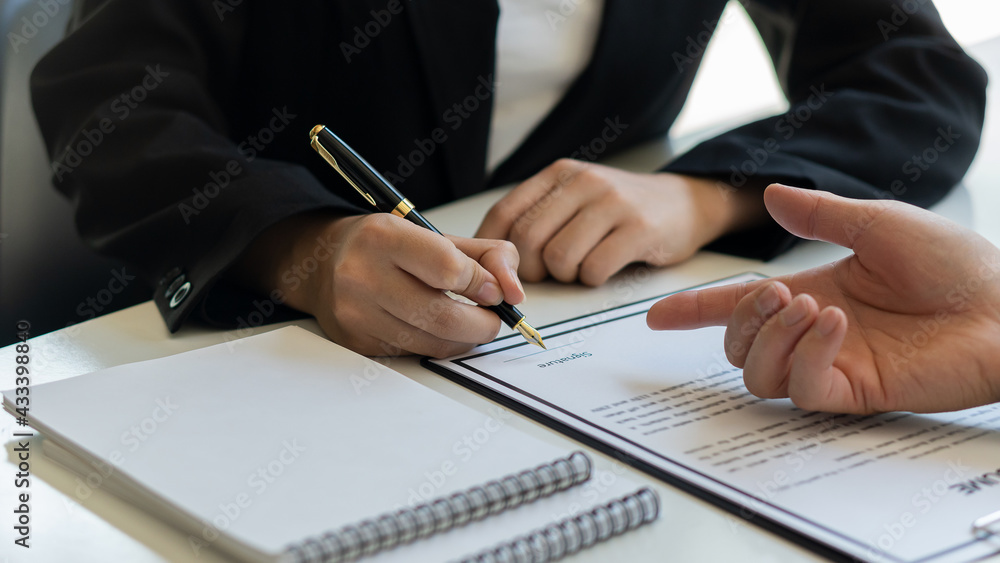 Employers read the resume of applicants at the interview room. The concept of hiring Employers read the resume of applicants at the interview room. The concept of hiring