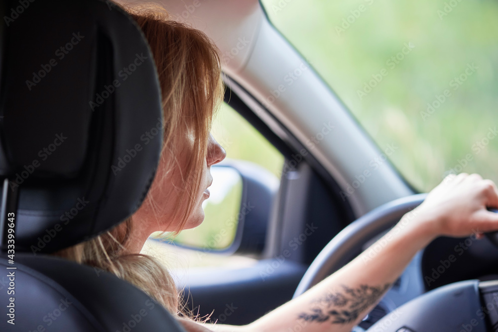 Blond woman driving a car automobile interior hands on wheel Blond woman driving a car automobile interior hands on wheel
