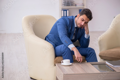 Young male employee waiting for business meeting