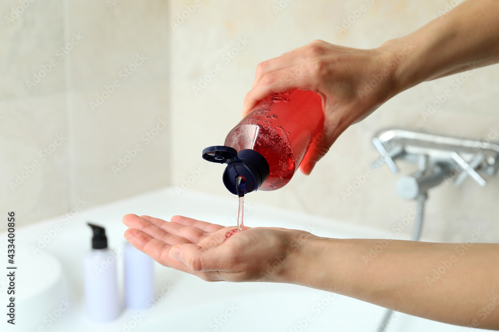 Naklejka premium Female hands apply shower gel, close up